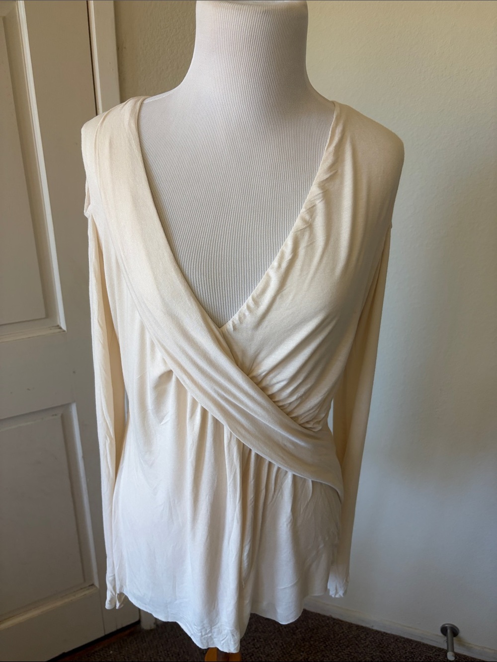 Bailey 44 beige light knit top with crisscross bust line , with open shoulders.
